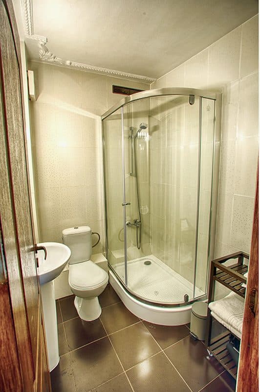 The studio's bathroom, with a curved-glass shower cubicle and a basin.